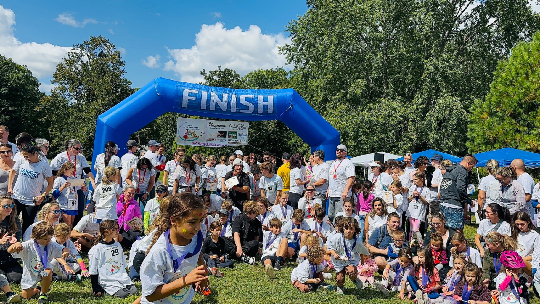 Crowd of participants beneath the finish arch